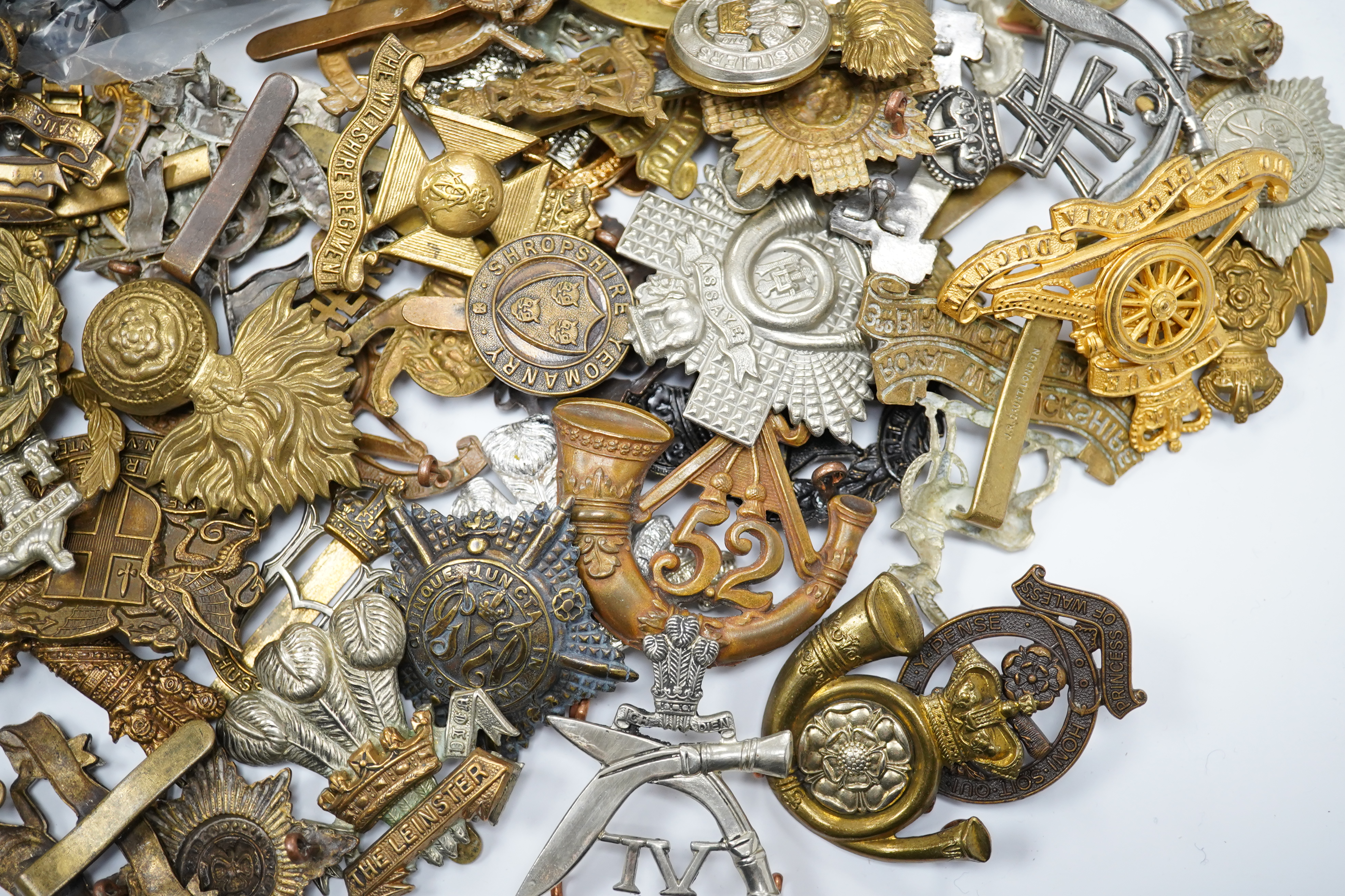 Seventy-eight military cap badges, including; the Royal Horse Artillery, the King’s Own, the Notts and Derby Regiment, the Royal Hussars, the Shropshire Yeomanry, the Herefordshire Regiment, the City of London Volunteer